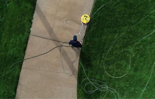 Professional pressure washing service cleaning a concrete walkway in Washington County, Maryland